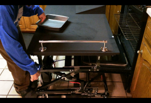 Figure 2. Client using the cart while operating the control switch at her oven.