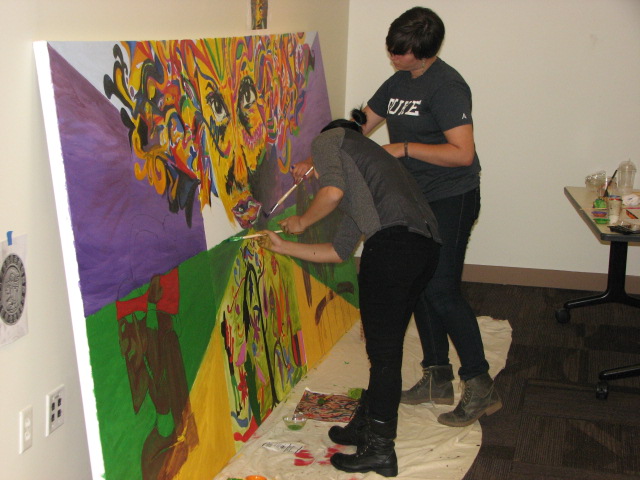 Students working on a collaborative painting. 