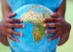 A pair of Black hands holding a globe