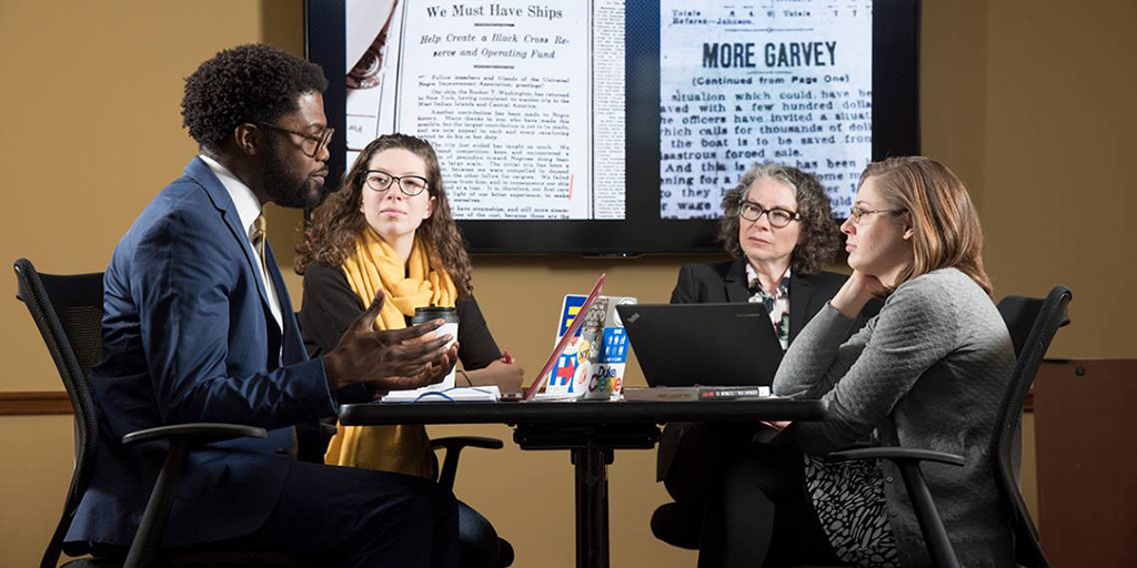 The English department launched a pilot lab for the Humanities Unbounded proposal, “Representing Migration.” Shown are Professors Charlotte Sussman and Jarvis McInnis with doctoral student Karen Little and sophomore Liddy Grantland. Photo by Les Todd