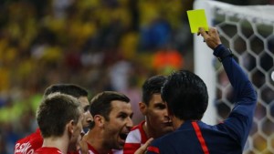 Referee Nishimura of Japan shows the yellow card to Croatia's Lovren, for a foul on Brazil's Fred, during the 2014 World Cup opening match at the Corinthians arena in Sao Paulo