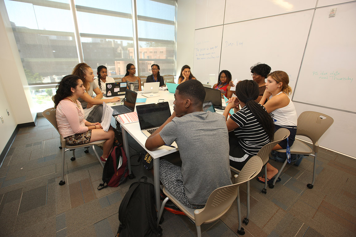 Photo of SBSI Scholars sitting together around a table