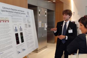 Caleb Spruill presenting poster with an audience member at NIDDK R25 Symposium