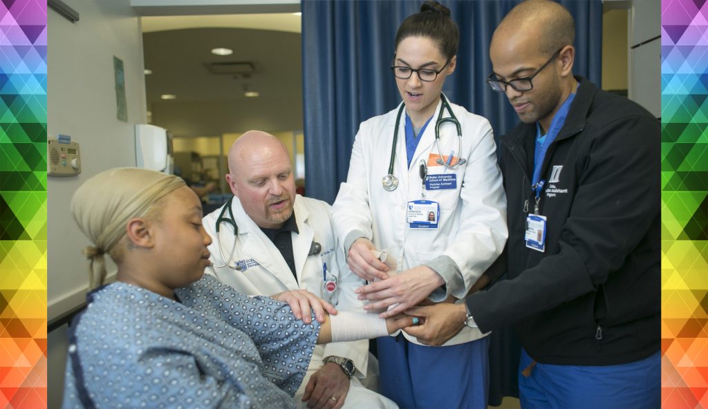 Photo of Duke Health staff interacting with a patient