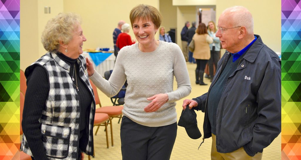 The first two participants enrolled in the MURDOCK Study reminisce with Dr. Newby at the 10th anniversary event in 2019.