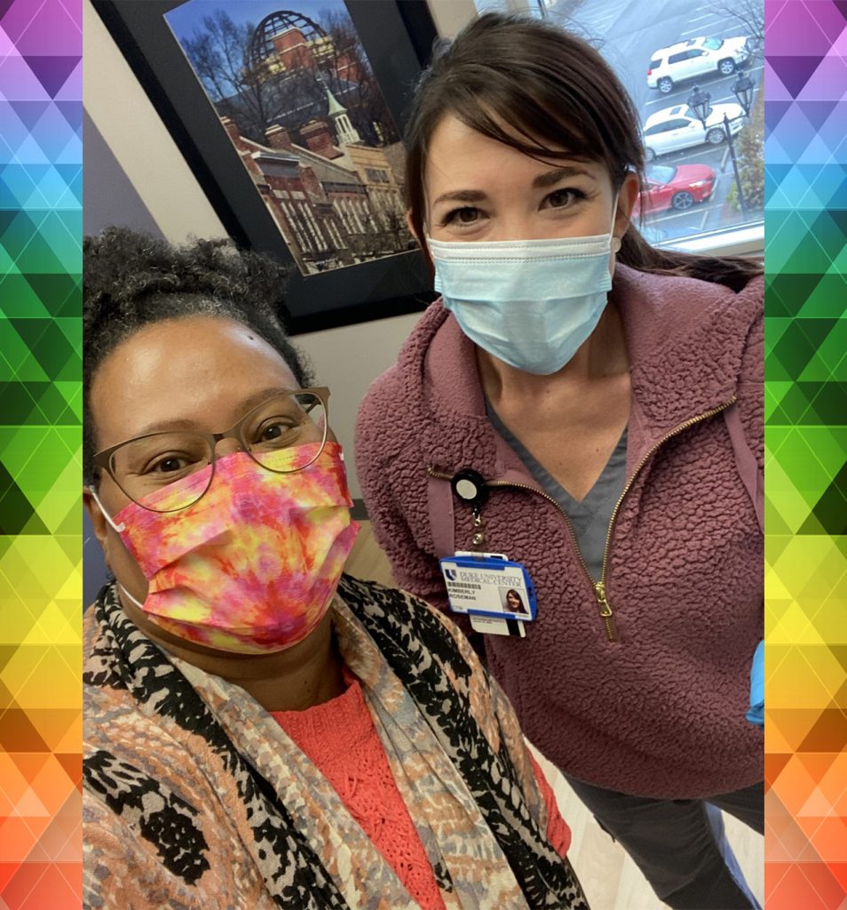 Selfie photo of two racially diverse female Duke employees wearing masks.