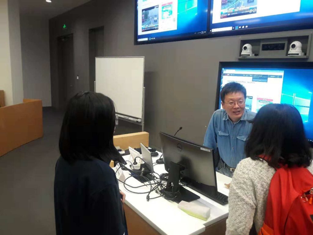 A photo of Dr. Seng talking with students