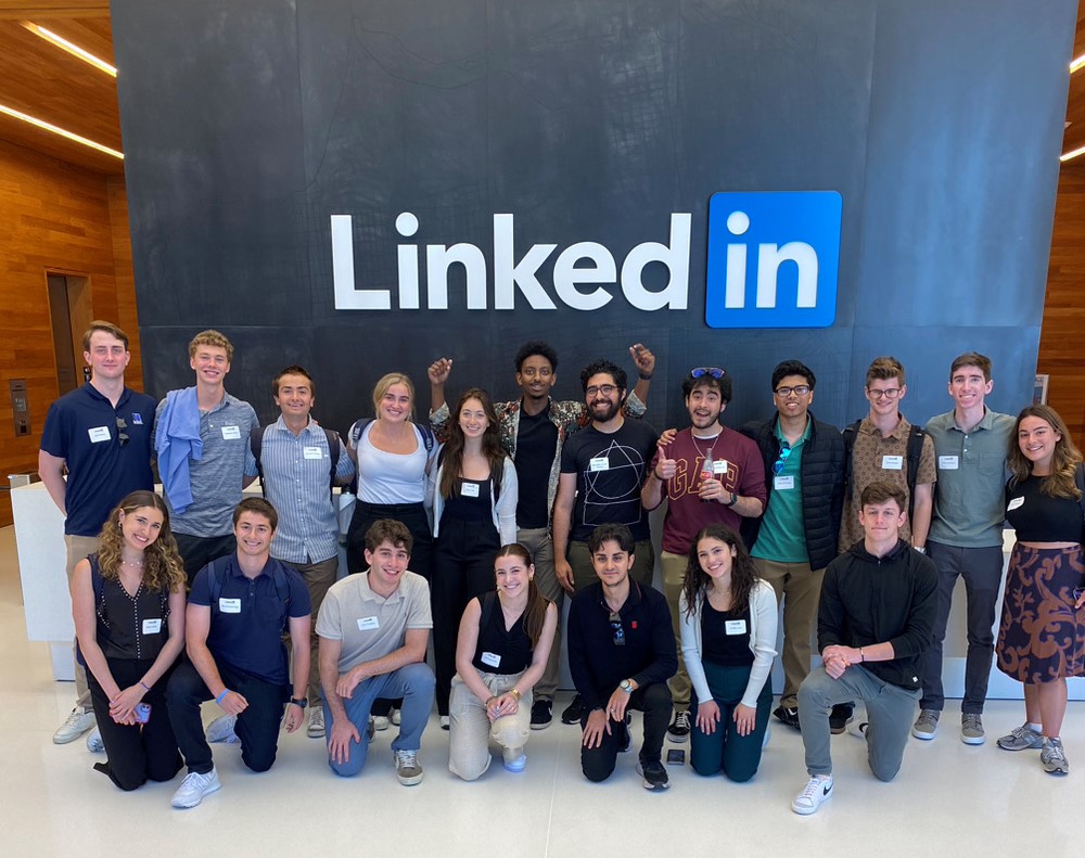 Group photo of students in front of a sign that says LinkedIn