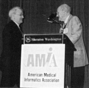 Ed Hammond presents Collen Medal to Morrie Collen in 1993. 