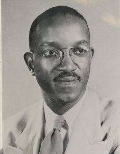 Photo of John Hope Franklin from 1963 - A black-and-white photo of an African American man, wearing glasses, with a mustache, and a tie and dress shirt