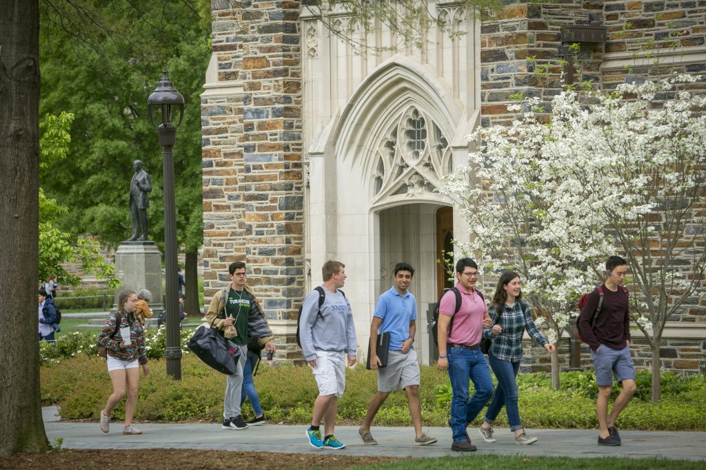 Students walk to and from class past Rubenstein Library through the Academic Quad on a beautiful Spring morning.