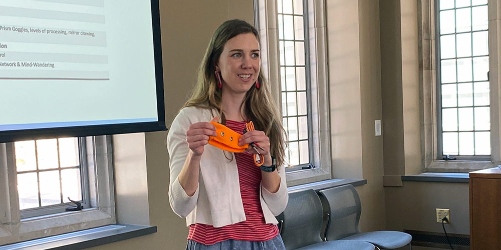 A graduate student holds up part of the science kit for her Duke summer course.