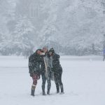 Duke students snap selfies on the Clocktower Quad during a January snowfall of several inches.
