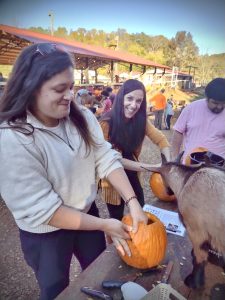 Kelsey and Val carving pumpkins