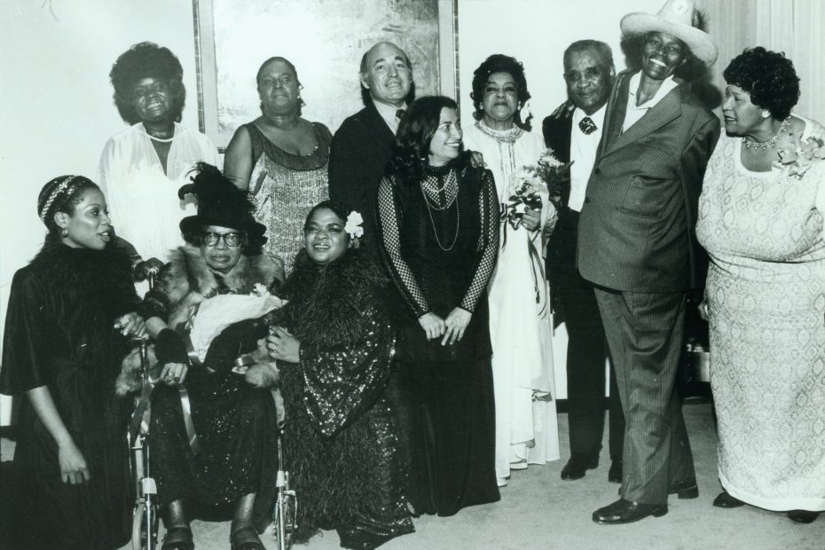 Blues is a Woman performers with Rosetta Reitz (standing, l to r): Koko Taylor, Linda Hopkins, George Wein, Rosetta Reitz, Adelaide Hall, Little Brother Montgomery, Big Mama Thornton, Beulah Bryant; (seated, l to r): Sharon Freeman, Sippie Wallace, Nell Carter. Copyright Barbara Weinberg Barefield. Image courtesy of Wikimedia.