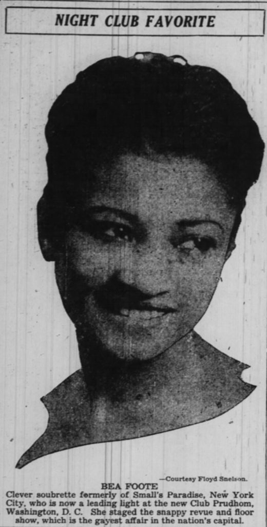 A black and white photo of a woman smiling and looking to her write, clipped from a newspaper.