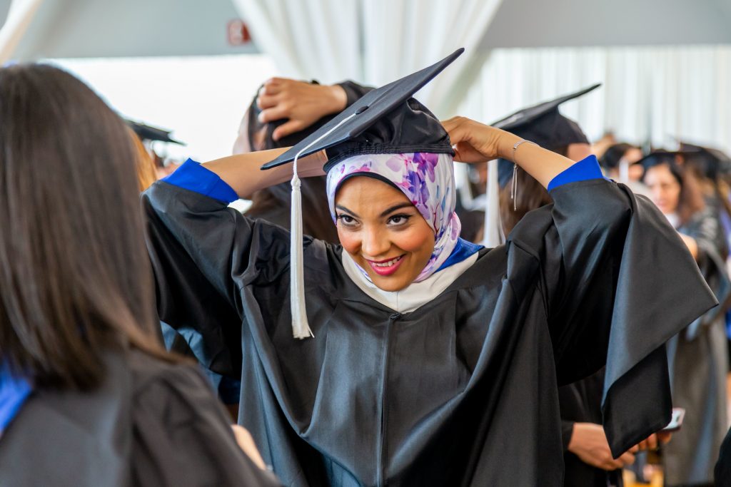 Women with headscarf and grduation cap