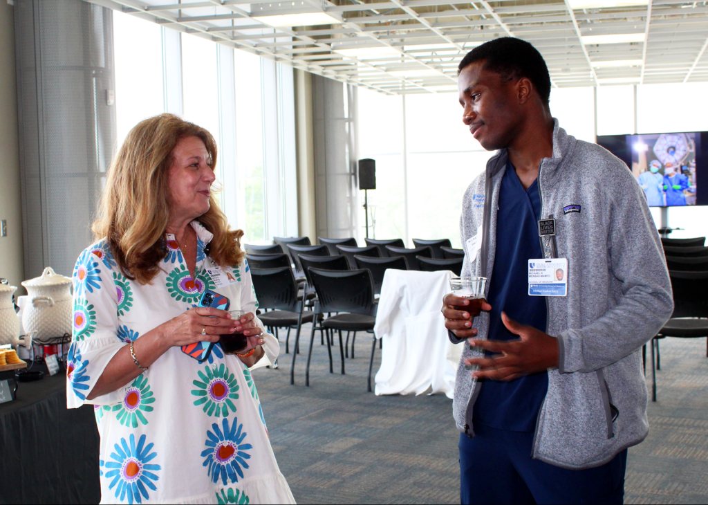 Gayle DiLalla, MD, Vice Chair of EDI, chats with medical student and ASPIRES mentee, Michael Mensah-Mamfo, at the ASPIRES year-end event