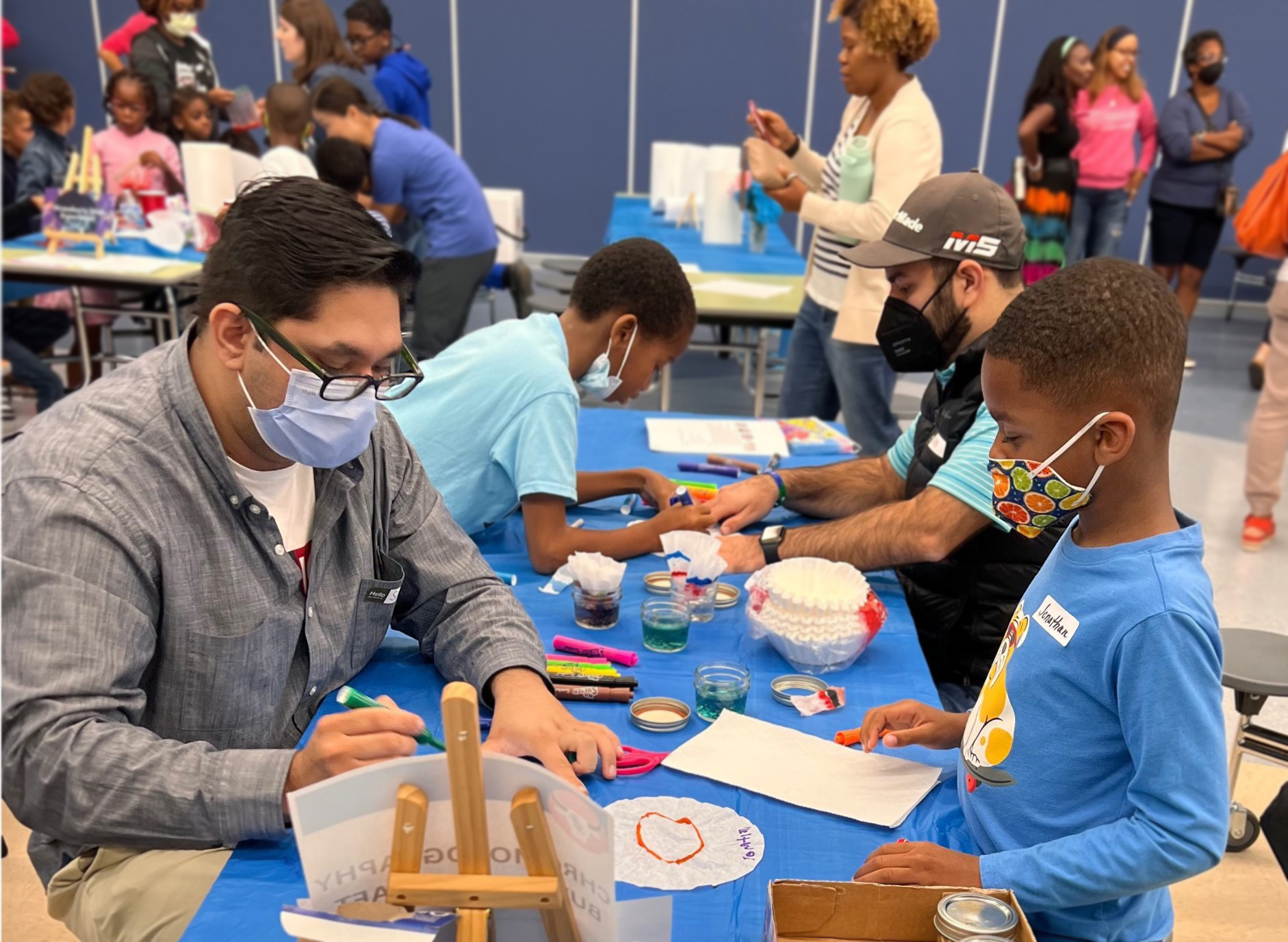 Duke Surgery volunteers at the Jack and Jill of Durham event teaching elementary students' fun science activities.