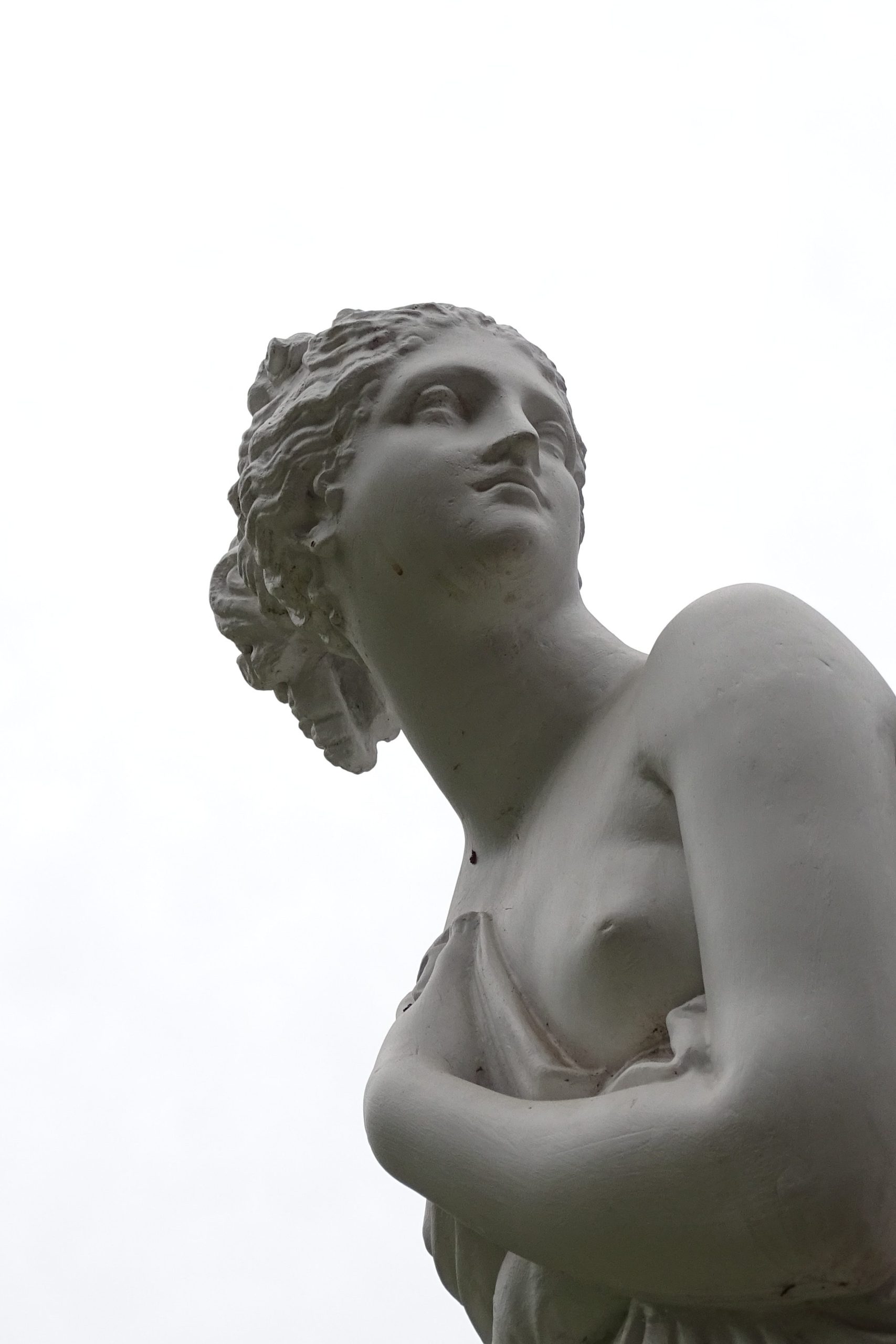 goddess statue in white stone on white background